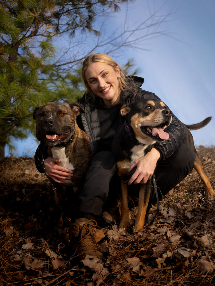 Stephanie, founder of Centred Canine, with two dogs near Ottawa